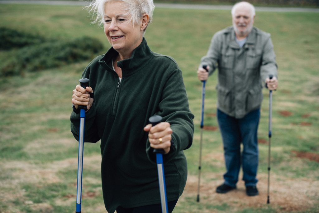 Active seniors with trekking poles